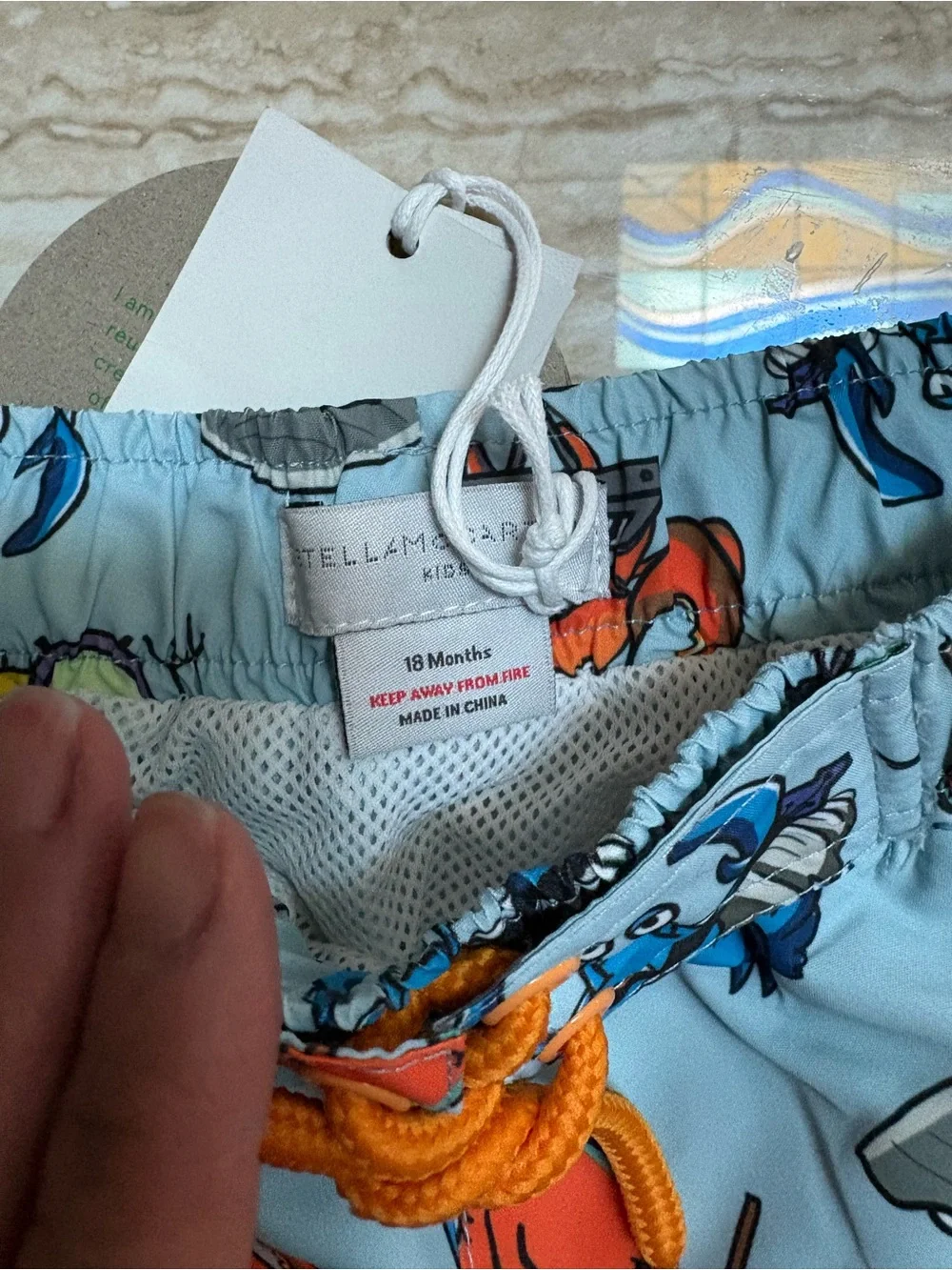 Stella McCartney Kids Light Blue Crab Print Swim Shorts with Orange Drawstring